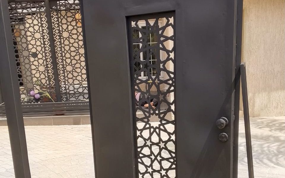 Black steel door with Islamic geometric laser-cut panel