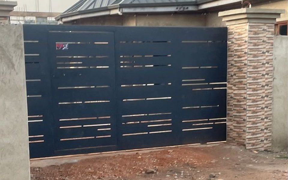 Black steel gate with horizontal slat cut-outs