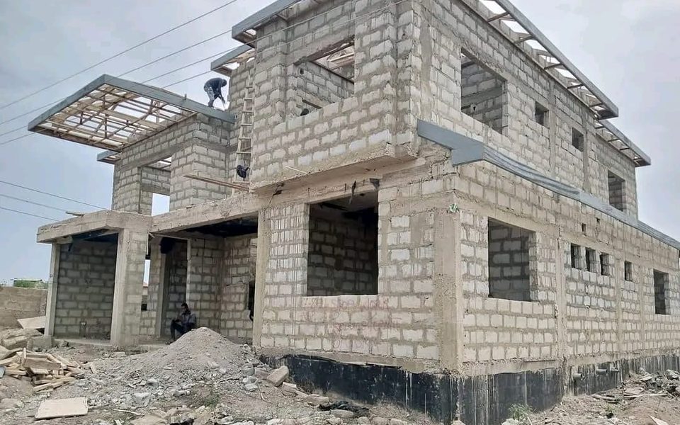 Block house under construction with roof framing in progress