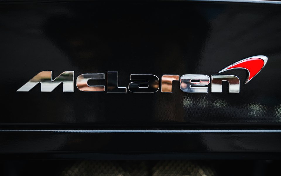 Chrome 3D badge lettering on a black panel