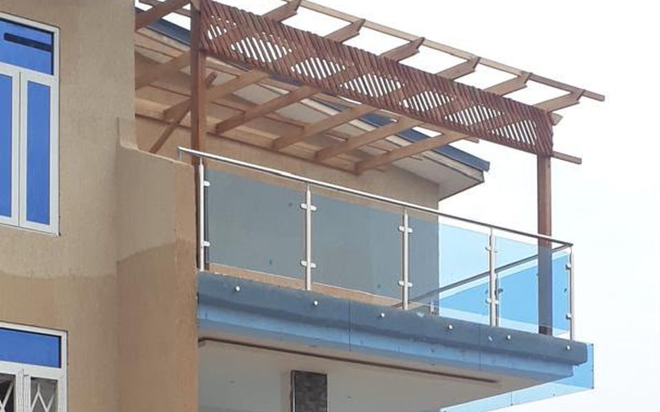 Completed glass balcony balustrade with a timber pergola