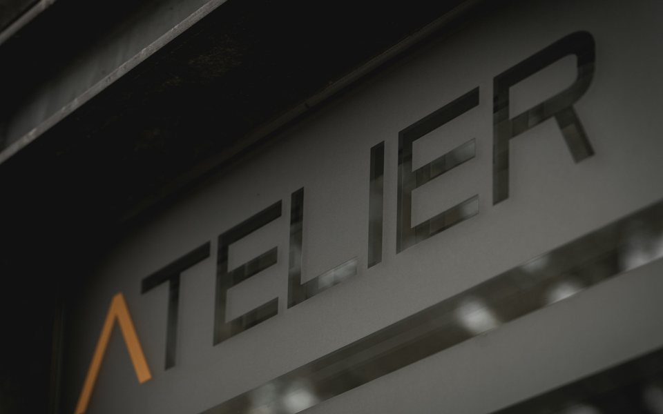 Cut-out lettering on a frosted panel above a shopfront