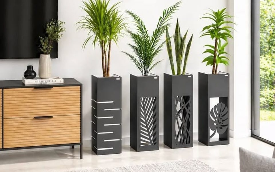 Four black steel planter stands with laser-cut leaf patterns