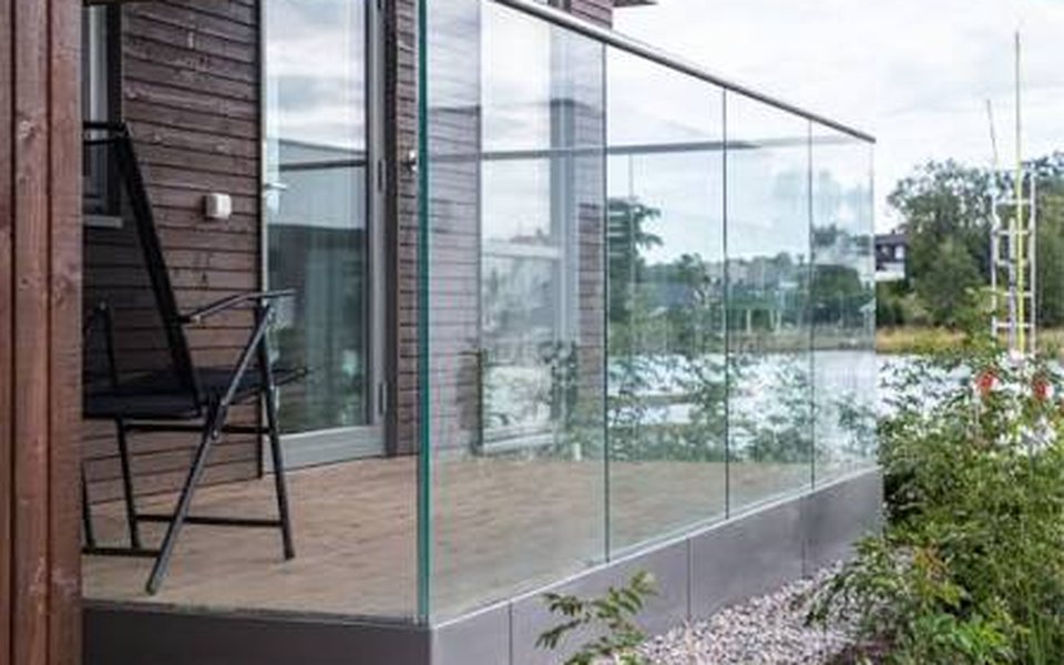 Frameless glass balustrade around a timber terrace
