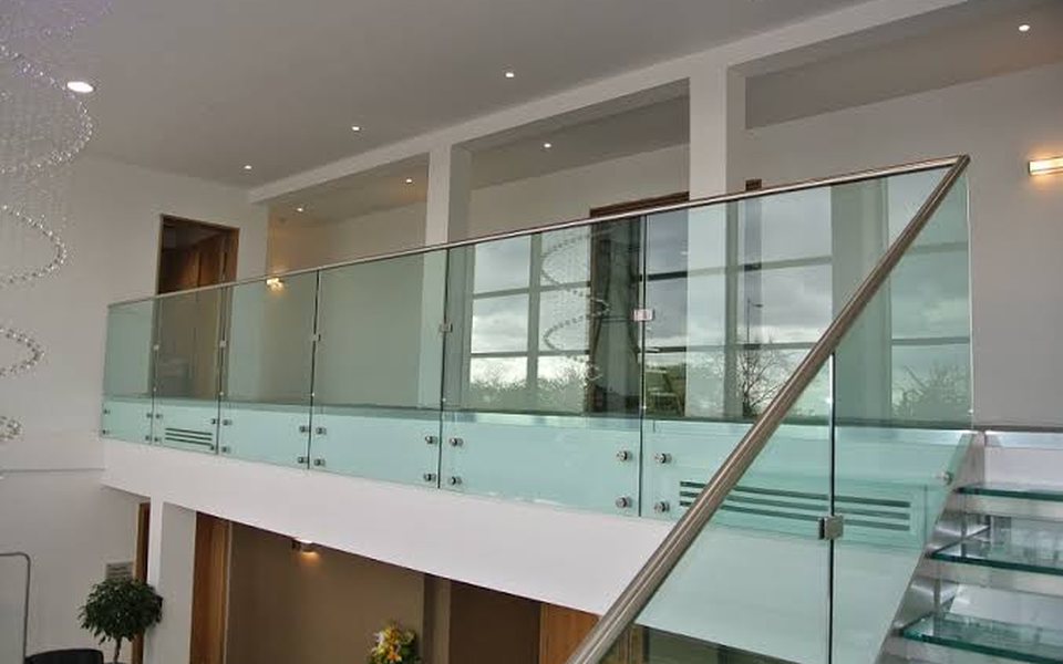 Frameless glass balustrade with stainless steel handrail on a mezzanine