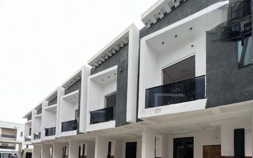 Row of modern two-storey townhouses with black glass balconies